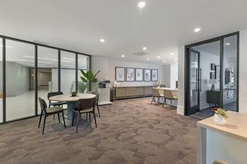 a conference room with tables and chairs and glass doors at Vue, San Pedro, CA, 90731